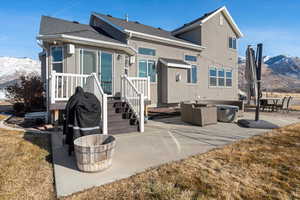 Rear view of property featuring a mountain view, outdoor lounge area, and a patio