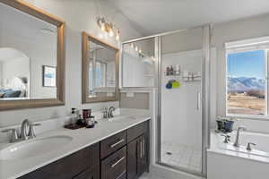 Bathroom featuring plus walk in shower and vanity