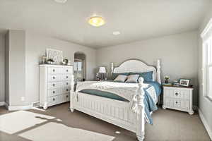 Bedroom featuring dark colored carpet