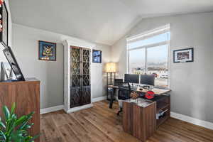 Office with hardwood / wood-style floors and vaulted ceiling