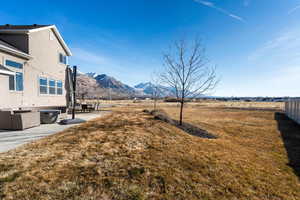 View of yard featuring a rural view, a mountain view, and a patio area