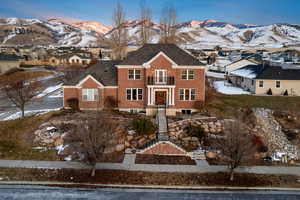 View of front of home featuring a mountain view and a balcony