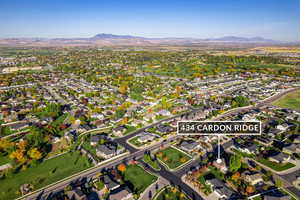 Aerial view of property's location with nearby suburban area and mountains