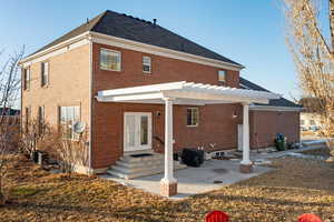 Rear view of property with a pergola, a patio area