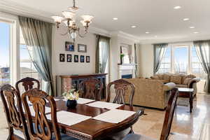 Dining room featuring crown molding and a notable chandelier