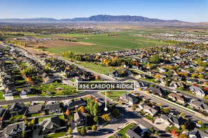 Aerial view of property's location featuring nearby suburban area and mountains