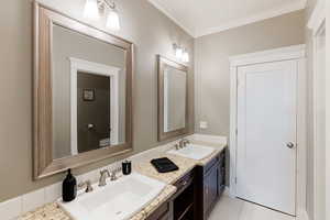 Bathroom featuring ornamental molding, toilet, tile patterned flooring, and vanity