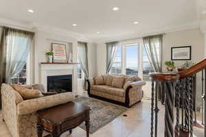 Marble tiled living room featuring crown molding