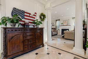 Entrance foyer with decorative columns and ornamental molding