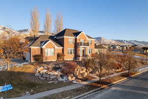 View of front of home with a balcony and a mountain view