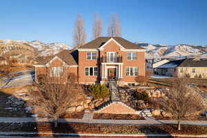 View of front facade featuring a mountain view and a balcony