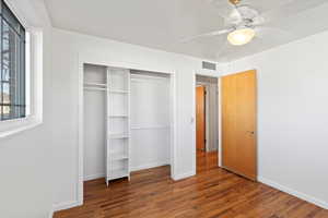 Unfurnished bedroom with hardwood / wood-style flooring, ceiling fan, and a closet