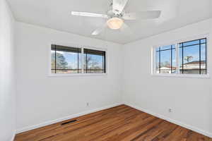 Unfurnished room featuring ceiling fan and hardwood / wood-style floors