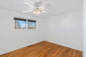 Unfurnished room featuring ceiling fan and hardwood / wood-style floors