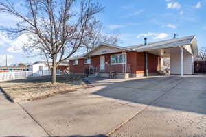 Ranch-style home featuring a carport