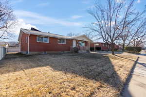 Single story home featuring a front lawn