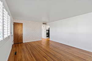 Empty room with hardwood / wood-style floors