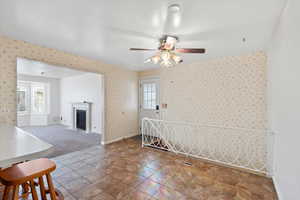 Empty room featuring plenty of natural light and ceiling fan