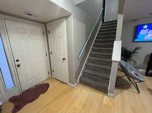 Stairs featuring wood-type flooring