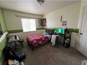 Bedroom featuring carpet and a textured ceiling