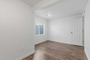 Empty room with dark hardwood / wood-style floors