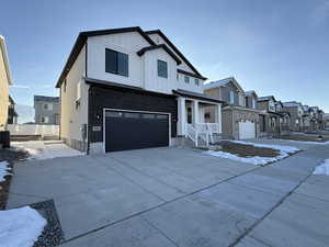 View of front of property with central AC unit and a garage