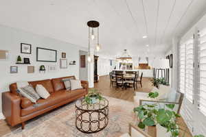 Living room with a chandelier and light hardwood / wood-style floors