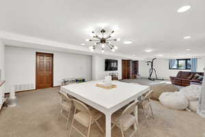 Dining space featuring light colored carpet