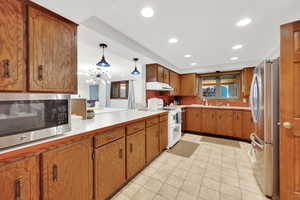 Kitchen with stainless steel appliances and pendant lighting