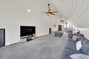 Living room featuring baseboard heating, wooden ceiling, vaulted ceiling, and dark colored carpet