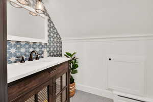 Bathroom with vanity and lofted ceiling