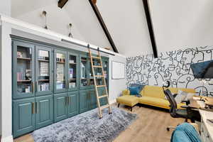 Sitting room featuring beam ceiling, high vaulted ceiling, and light wood-type flooring