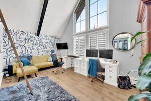 Office area featuring beamed ceiling, a baseboard heating unit, high vaulted ceiling, and light hardwood / wood-style flooring