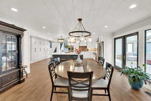 Dining area featuring wooden ceiling, light hardwood / wood-style floors, and french doors