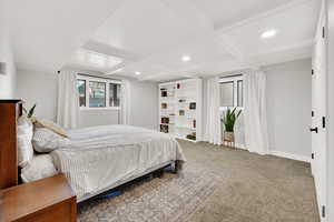 Bedroom featuring coffered ceiling, carpet floors, and beamed ceiling