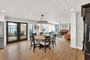 Dining area featuring light hardwood / wood-style floors and french doors