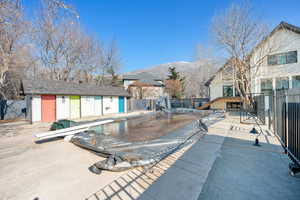 View of swimming pool with a mountain view, an outbuilding, and a patio area