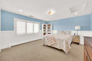 Carpeted bedroom featuring baseboard heating