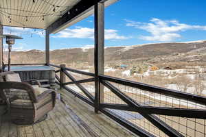 Snow covered deck with a mountain view