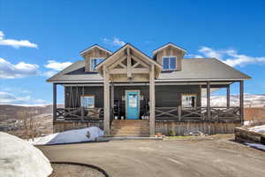 View of front facade with a mountain view and a porch