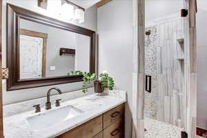 Bathroom with a shower with door and vanity