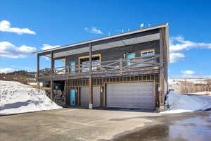 Exterior space featuring a garage and a balcony