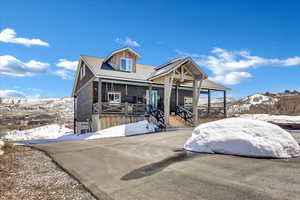 View of front of home featuring a mountain view and a porch