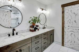 Bathroom with vanity, tile patterned floors, and walk in shower