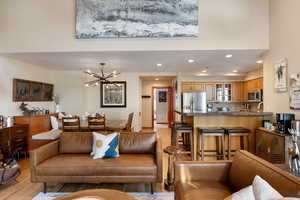 Living room with a notable chandelier and light hardwood / wood-style floors