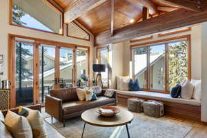 Living room with wood-type flooring, high vaulted ceiling, wood ceiling, and beam ceiling