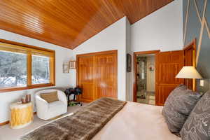 Bedroom featuring vaulted ceiling, carpet floors, and wooden ceiling