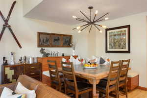 Dining room with an inviting chandelier and light wood-type flooring