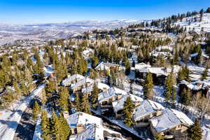 Snowy aerial view featuring a mountain view