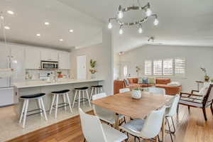 Dining room featuring vaulted ceiling and light wood-type flooring